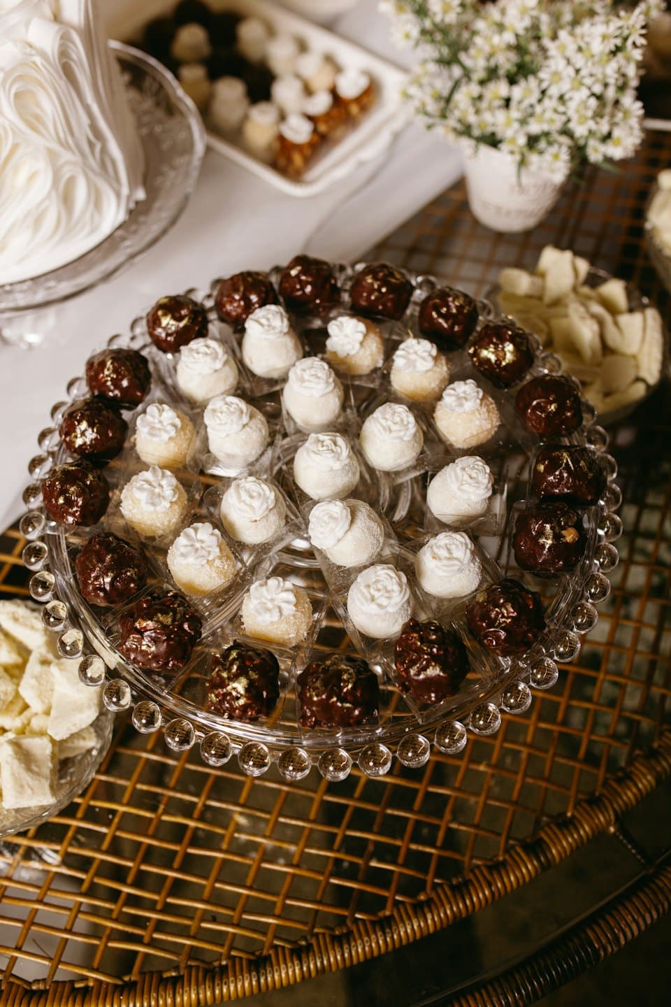 Gourmet chocolate truffles and sweets arranged on a glass platter.