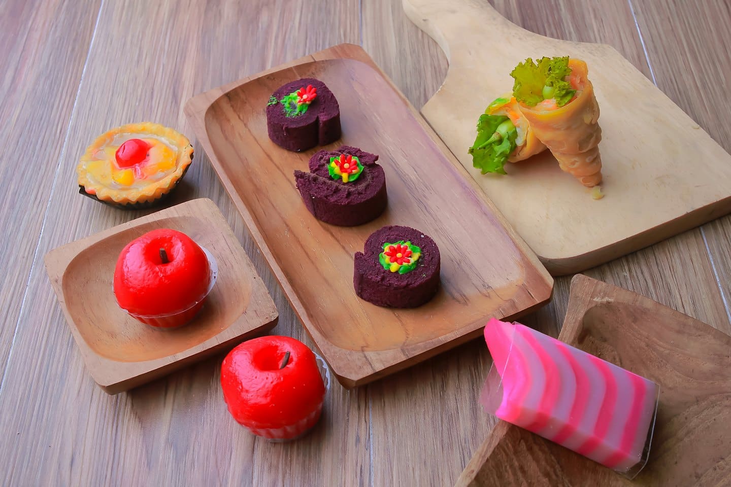 Colorful assortment of traditional desserts and snacks on wooden boards.