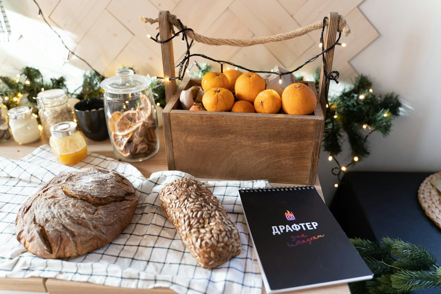Rustic baked goods, citrus, and pantry items on a checkered tablecloth.